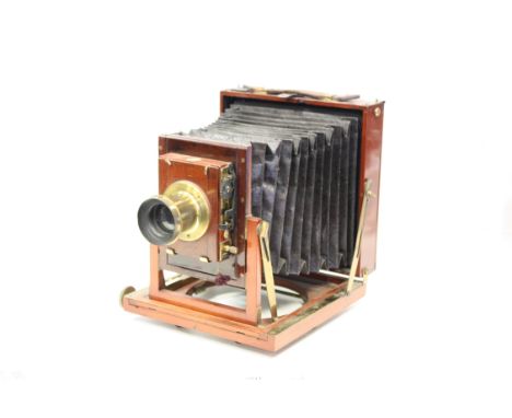 A Thornton Pickard Half-Plate Mahogany Field Camera, with Thornton Pickard 7x5 Rapid Rectalinear brass lens, together with 3 