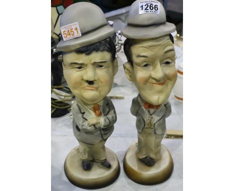 Pair of ceramic Laurel and Hardy comic figurines. Not available for in-house P&amp;P, contact Paul O'Hea at Mailboxes on 0192