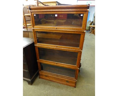 An early 20th Century Globe Wernicke oak four tier stacking sectional bookcase