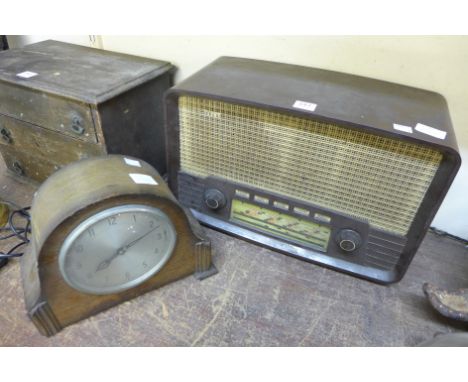 A Bakelite radiogram and oak electric mantel clock