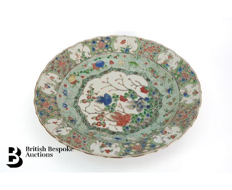 Chinese famille vert circular dish, Kangxi period, painted at the centre with a bordered and cusped circular panel of floweri