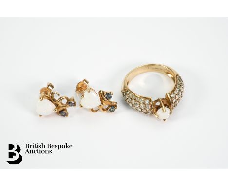 A 9ct gold diamond and opal ring, set with central opal measuring approx. 5 mm, with 1ct of diamonds to shoulders, size N. To