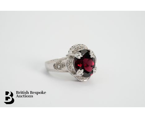 A 9ct gold garnet ring, the oval garnet measuring approx. 12 x 10mm, size K, weight approx. 6.9gms.
