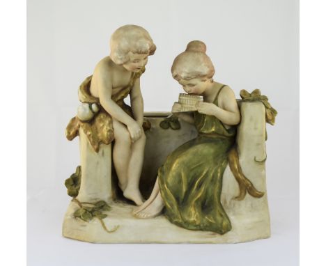 Royal Dux Group Figure of a Boy and Girl Seated, The Girl Playing a Musical Instrument. c.1900. Pink Triangle to Underside. E
