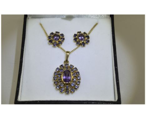 Amethyst and Iolite Pendant and Earrings, set in 9ct gold with chain; the pendant comprises an oval cut, faceted amethyst, be