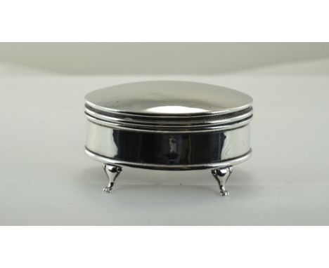 George V Silver Lidded Oval Shaped Trinket Box, Raised on 4 Scroll Feet. 1.75 Inches High, 3.25 Inches Diameter. 135 grams. 