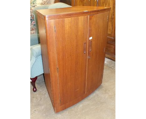 A Turnidge 1960's/70's teak bow-fronted cocktail cabinet fitted with two doors, two sliding glass doors and fold-over top, 82