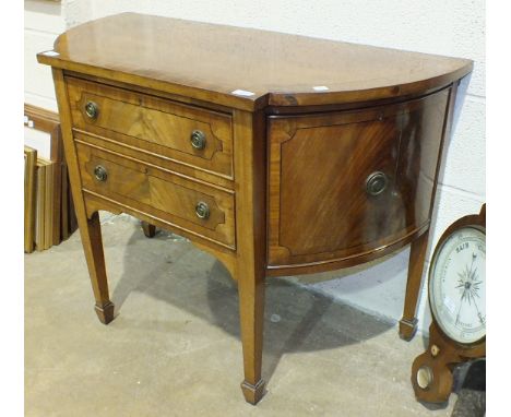 A small mahogany bow-fronted sideboard on square tapered legs with spade feet, 107cm wide.