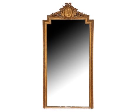 Mirror in classic gold-colored frame with richly decorated crest with bow and medallion with woman portrait, in Empire style,