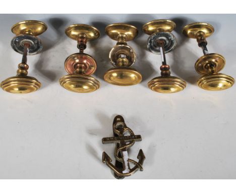 A group of five pairs of 19th Century Victorian brass door handles of oval stepped form. Each pair having a round brass back 