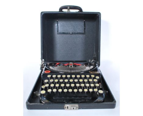 A vintage early 20th Century Remington portable typewriter with original fitted carry case dating to 1922, glass keys with Re