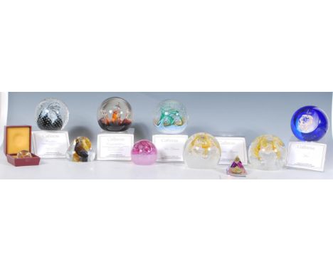 A collection of Caithness paperweights to include a selection of styles including control bubble and swirl, a blue glass Leo 