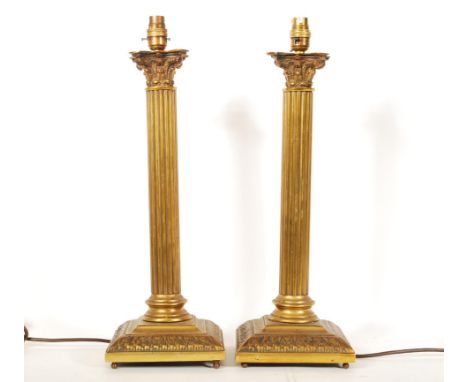 A pair of 20th Century antique style brass table lamp bases in the form of corinthian columns having reeded column with scrol