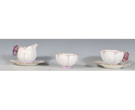 An Aynsley purple butterfly handle and leaf moulded part tea service compressing of one tea cup and saucer, sugar bowl and li