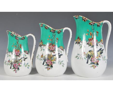 A set of three 19th Century Victorian era graduating ceramic water jugs having transfer printed green and white ground with f