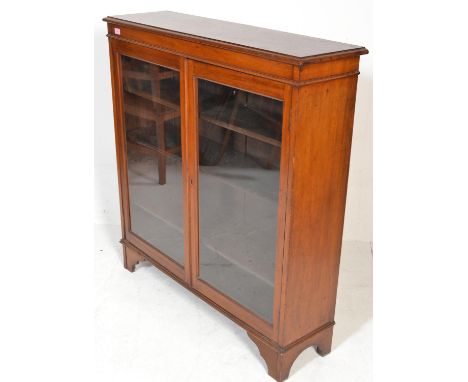 A 19th Century Victorian mahogany library bookcase cabinet having twin full length glazed panel doors housing adjustable shel