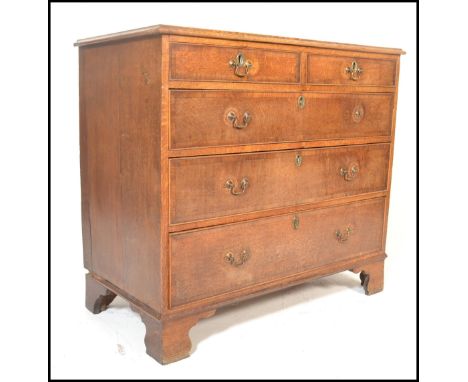A Georgian late 18th Century oak chest of two short over three long drawers having crossbanded decoration, with brass swan ne