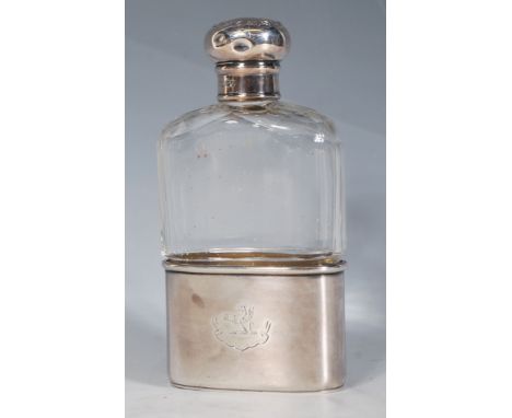 A Late Victorian / Edwardian faceted cut glass and silver hallmarked hip flask having a screw bun cover with round motifs and