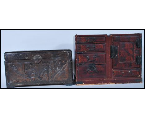 A late 19th Century Chinese carved wooden table top box decorated with carved panels depicting narrative scenes having a bras