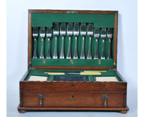 A 20th Century Hammond Creake &amp; Co cutlery canteen set within a wooden case with hinged lid and drawer, having a fully ap