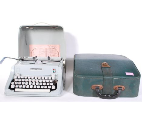 A vintage Hermes Media 3 Swiss made 20th Century portable typewriter in case, together with a faux green leather vintage Herm