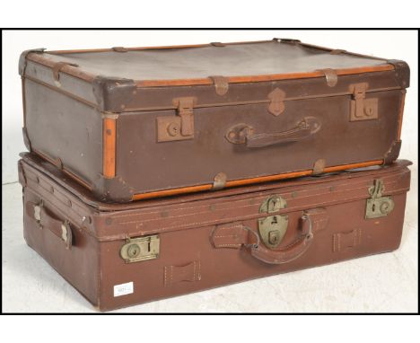 Two vintage 20th Century suitcase trunks to include a brown leather trunk painted with initials W. E. F. together with a brow