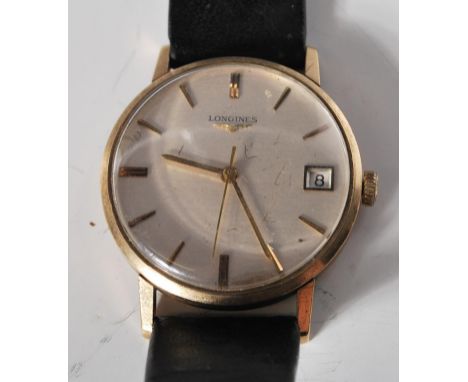 A vintage gentleman's 9ct gold Longines wrist watch having a round face with a silvered dial with gilt baton markings to the 