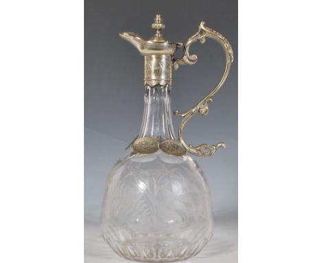 A 20th Century claret jug of bulbous tapering form having a faceted neck with etched foliate decoration having white meta mou