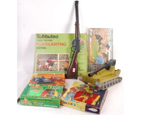 A collection of vintage boxed toys and games to include: Subbuteo Floodlights Edition, Waddingtons Table Soccer game, a charm