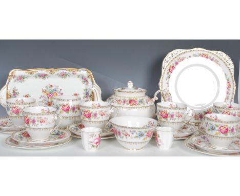 A vintage grafton china tea service in the Malvern pattern transfer printed with pink floral sprays and geometric borders con