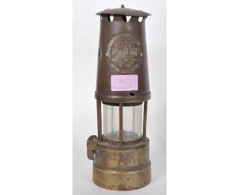 A late 19th / early 20th Century Eccles Manchester miners lamp of typical brass construction with applied brass label reading