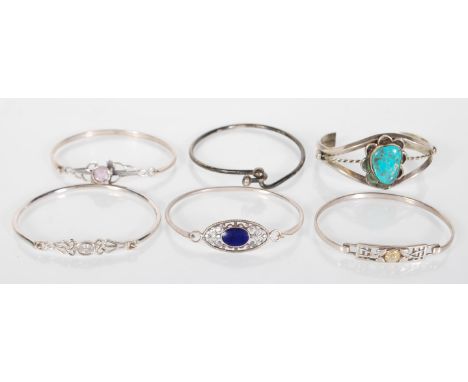 A selection of 20th Century silver bangle bracelets to include four having hook and eye clasp designs set set with coloured s