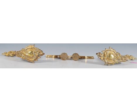 A pair of late 19th Century French gilded shelf supports / brackets of decorative scroll form with embossed foliate decoratio