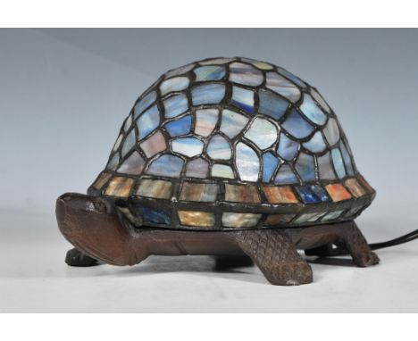 A 20th Century Tiffany style desk top table lamp in the form of a tortoise, the shell being leaded with blue glass panels. Me