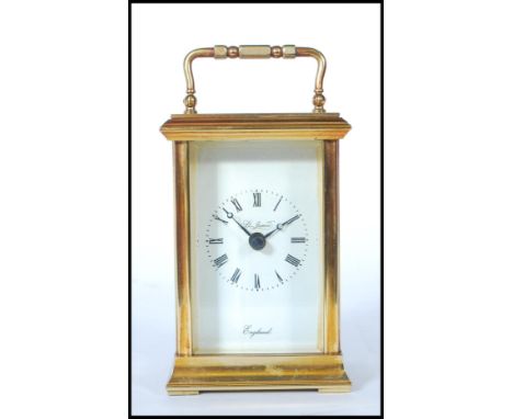 A St James 20th century century brass cased carriage clock with roman numeral chapter ring and faceted hands having notation 