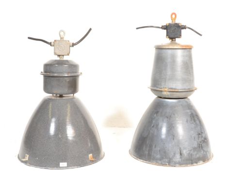 A near matching pair of large vintage industrial 20th Century factory black enamel ceiling lights. Each retaining the origina