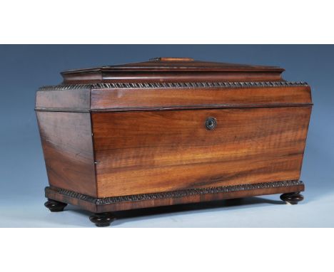 A 19th Century Georgian coromandel wood tea caddy of sarcophagus form having carved beaded banding to the edges, the interior