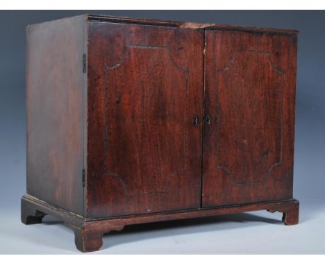 A 19th Century mahogany apprentice piece two door cabinet, the doors with carved detail to the front, brass escutcheons&nbsp;