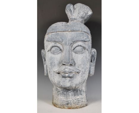 A 20th Century ornamental composite garden statue head depicting a Chinese warrior with raised detailing. Measure 44cm tall.