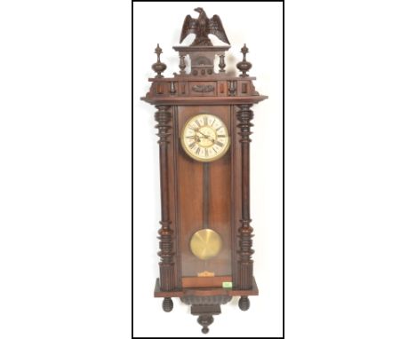 A 19th Century Victorian walnut cased Vienna regulator wall clock in the manner of Gustav Becker, the case surmounted by an e