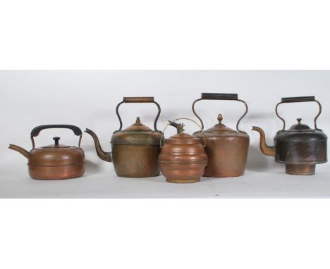 A group of four decorative copper kettles dating from the 19th Century and latter to include Victorian examples, Arts and Cra