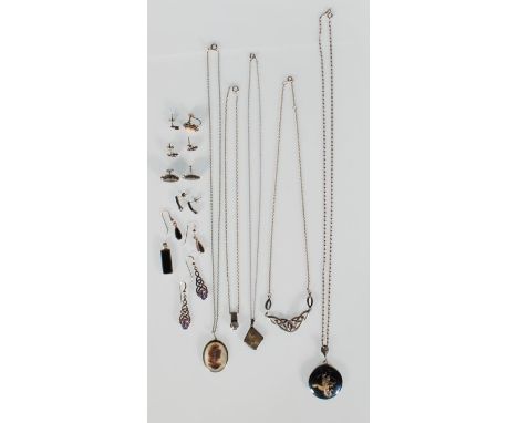 A selection of silver jewellery to include a pendant necklace set with a white stone, an engine turned locket, a knot design 