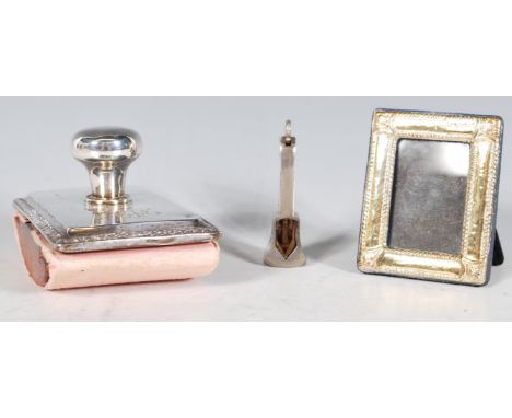 A selection of silver items to include a stamped 925 miniature photo frame with repousse decoration, a Henry Matthews silver 