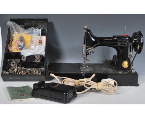 A 20th Century vintage Singer Featherlite 221K sewing appears complete with accessories / manual etc. No case. Measures 23cm 