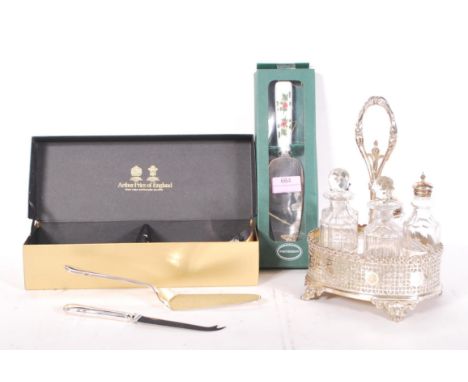 A five piece silver plated and cut glass cruet set within a fret pierced gallery surround stand having central carry handle r