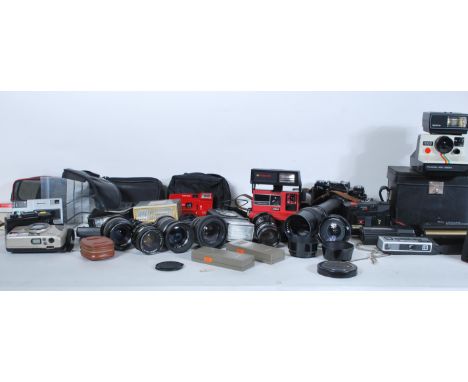 A collection of vintage film cameras and equipment to include a cased Polaroid land Camera, a Zenit TTL camera with a Prinzga