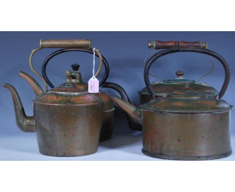 A group of copper kettles dating from the 19th Century Victorian era and latter examples to include one of oval form having a