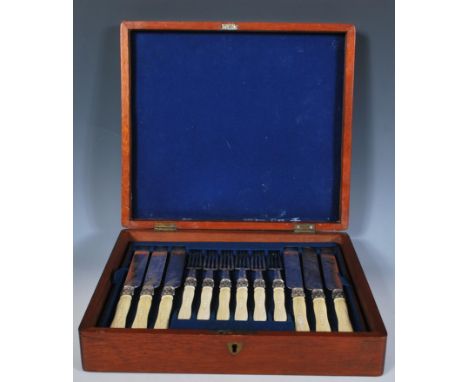 An early 20th Century Edwardian mahogany cased cutlery service consisting of twelve knifes and twelve forks. The knifes and f