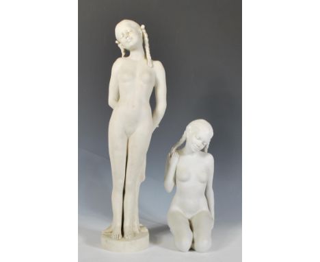 Two 20th Century blanc de chine ceramic bisque figurines depicting nude women having plaited hair to include one standing fig
