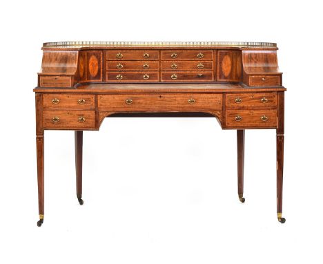 A 19th century Carlton House writing desk, with a galleried super structure and an arrangement of short drawers, cupboards an